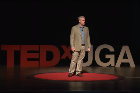 Keith Campbell stands on the UGA Tedx Stage and speaks about his research