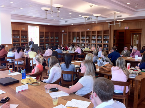 Students and faculty listening to Dr. Campbell (Chair) speak