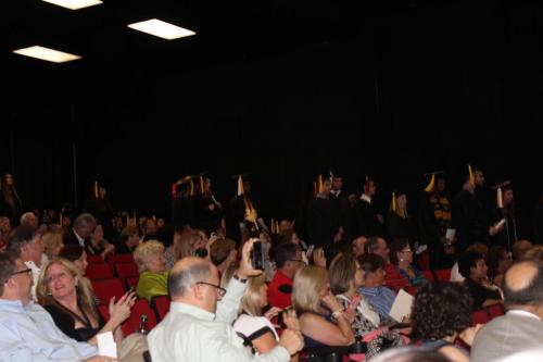 The graduation audience with graduates walking down the aisle