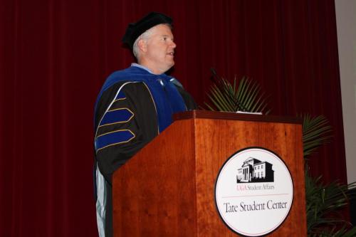 Department head Keith Campbell speaking at the podium