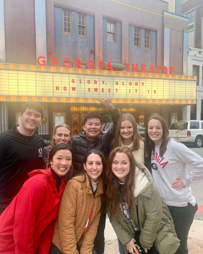IO Students posing in front of Georgia Theatre. GO DAWGS!